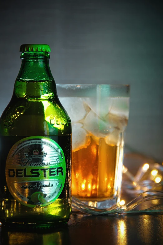 a beer and glass next to some ice