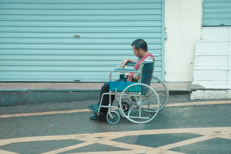 a person sitting in a blue wheelchair