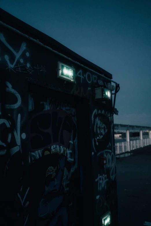 a train traveling through a dark city next to street lights