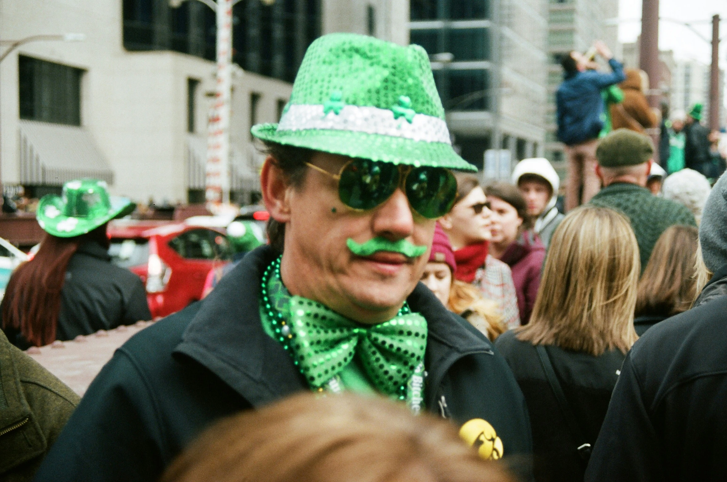 a man wearing a green hat and bow tie