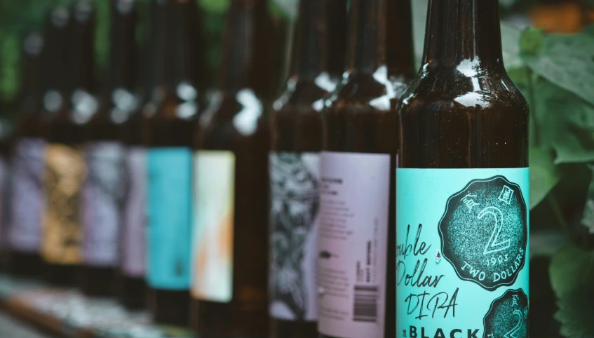 six bottles of beer lined up on a shelf