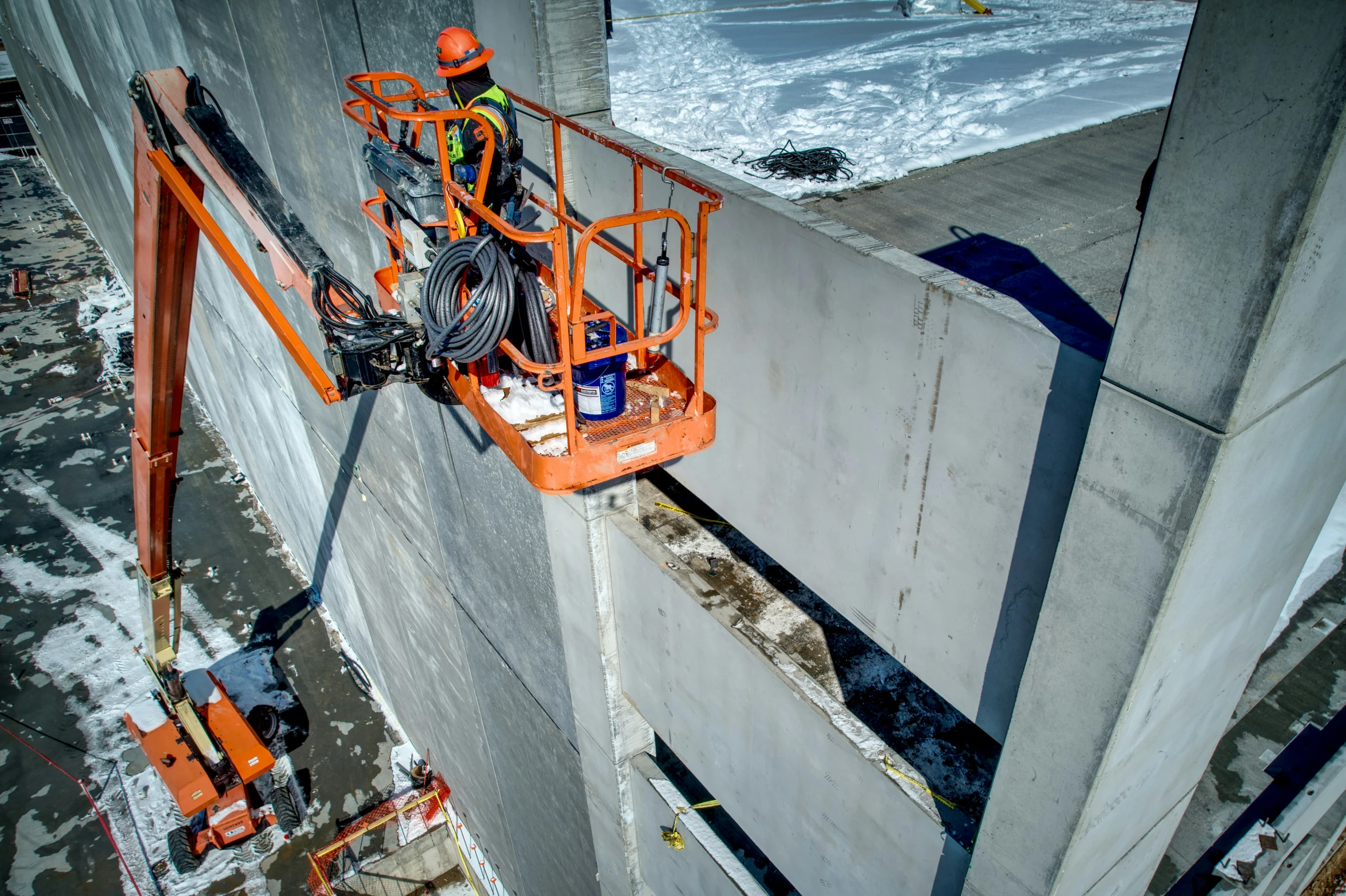 construction workers are on orange platforms to remove the walls from their floors