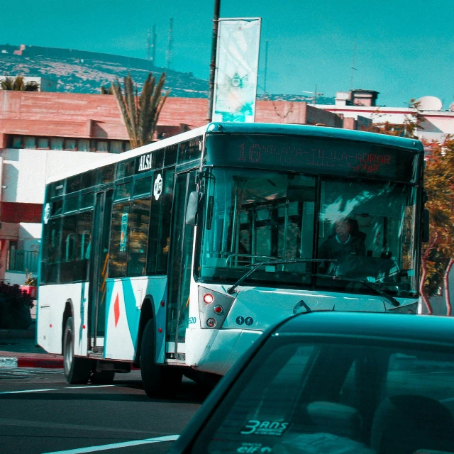 a bus driving down the street in front of a building