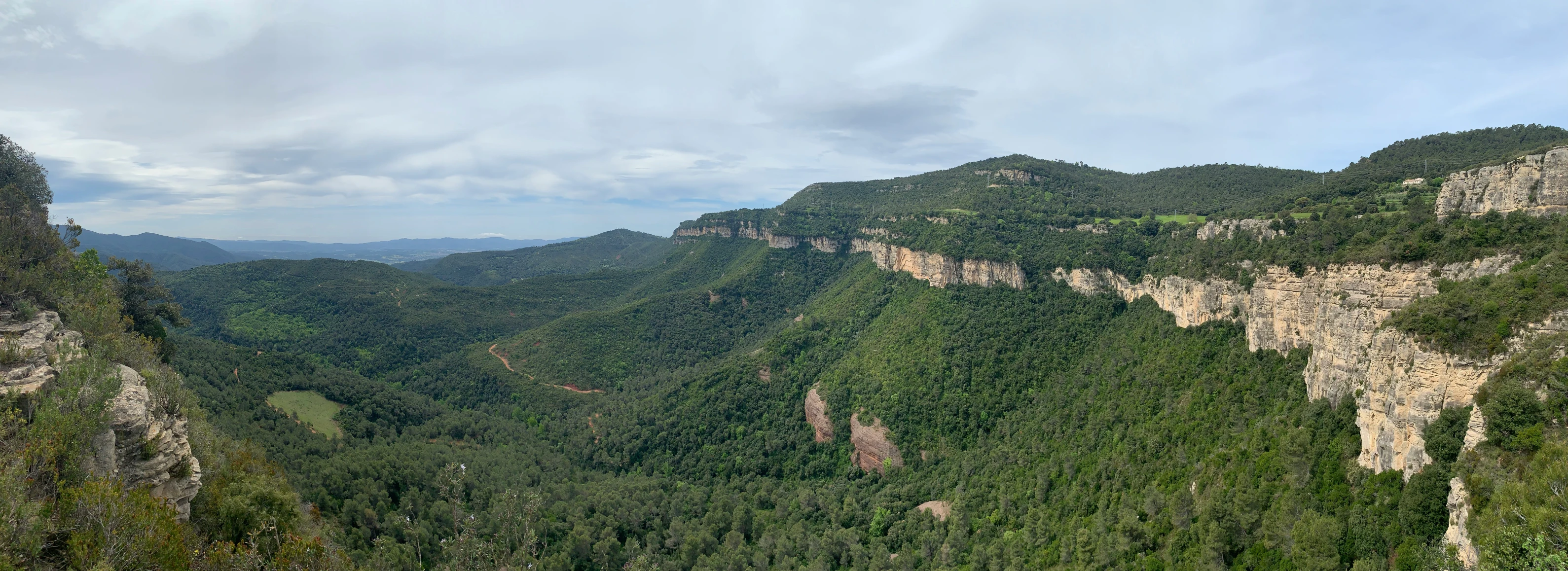 the landscape is scenic, showing a vast valley in the background