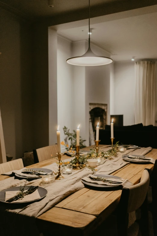 the table is set with place settings and lit candles