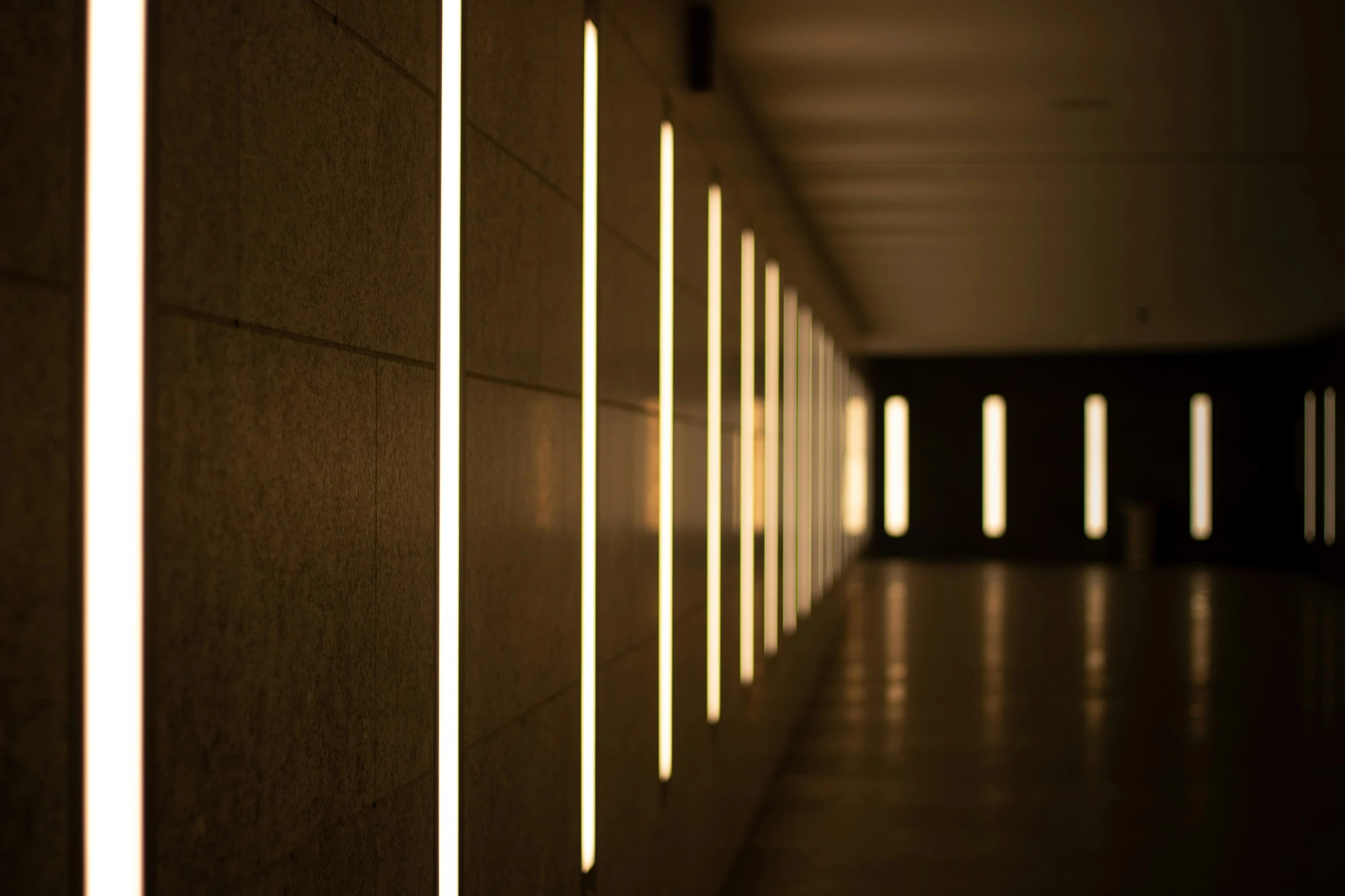 a hallway lined with lightening lines leading into a dark room