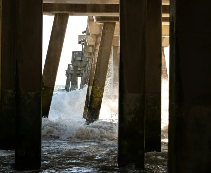 a large ship is crashing under an overpass