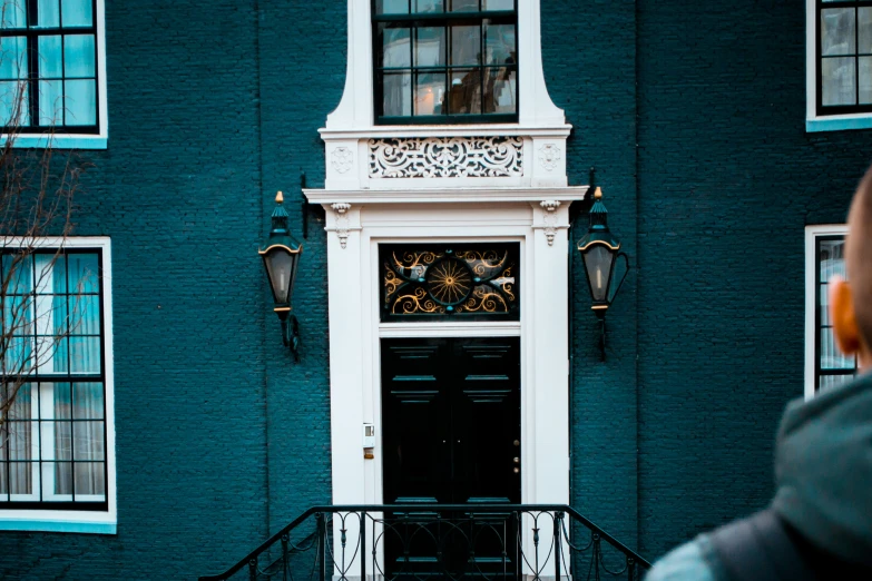 a man walking by an ornately decorated door