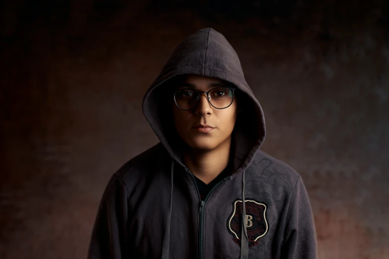 a person wearing a hoodie with a patch on the chest