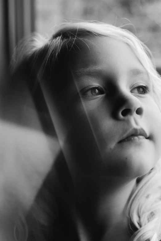 a black and white po of a small child with long hair