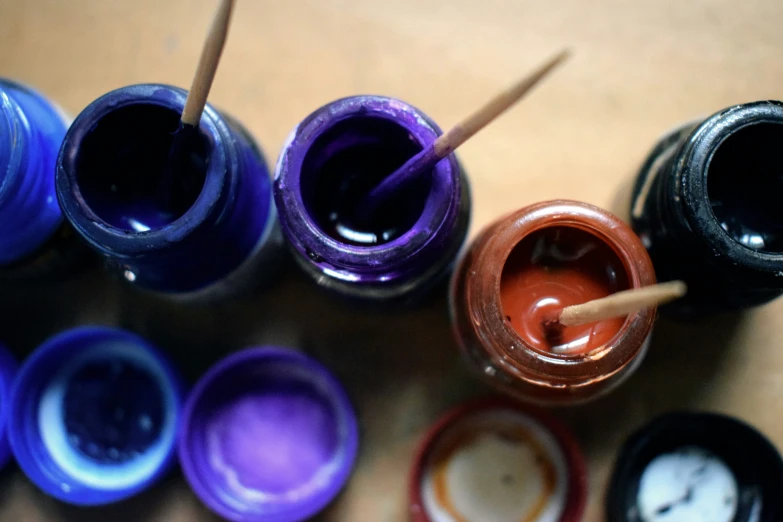 many different types of paints are on the table