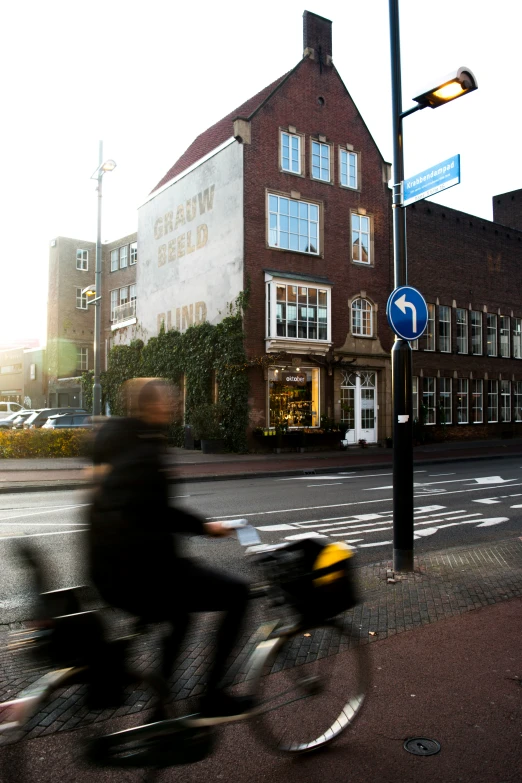 a person on a bicycle riding down the road