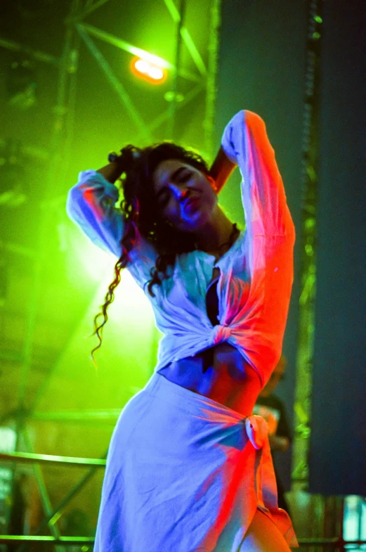 a woman in white dress performing on stage