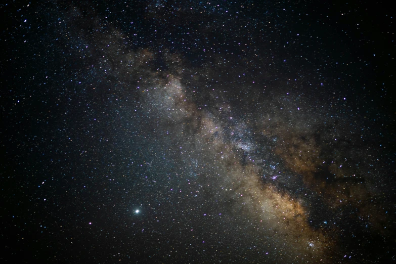 some bright stars shining through the sky in a field