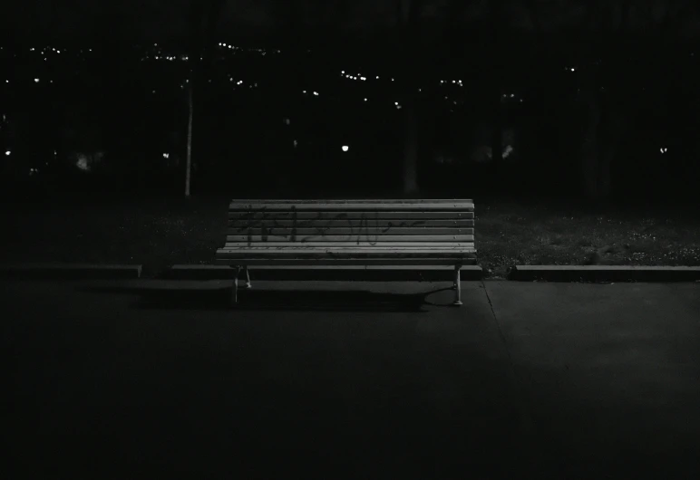 a bench sits at the edge of the sidewalk