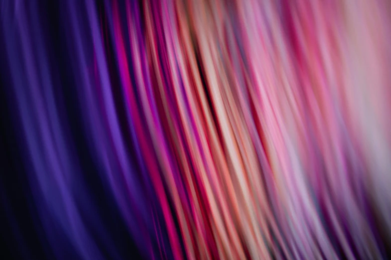 the hair of a woman with red, pink and purple highlights