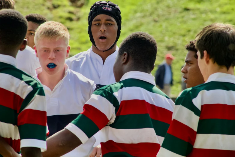 young men are talking and wearing striped shirts