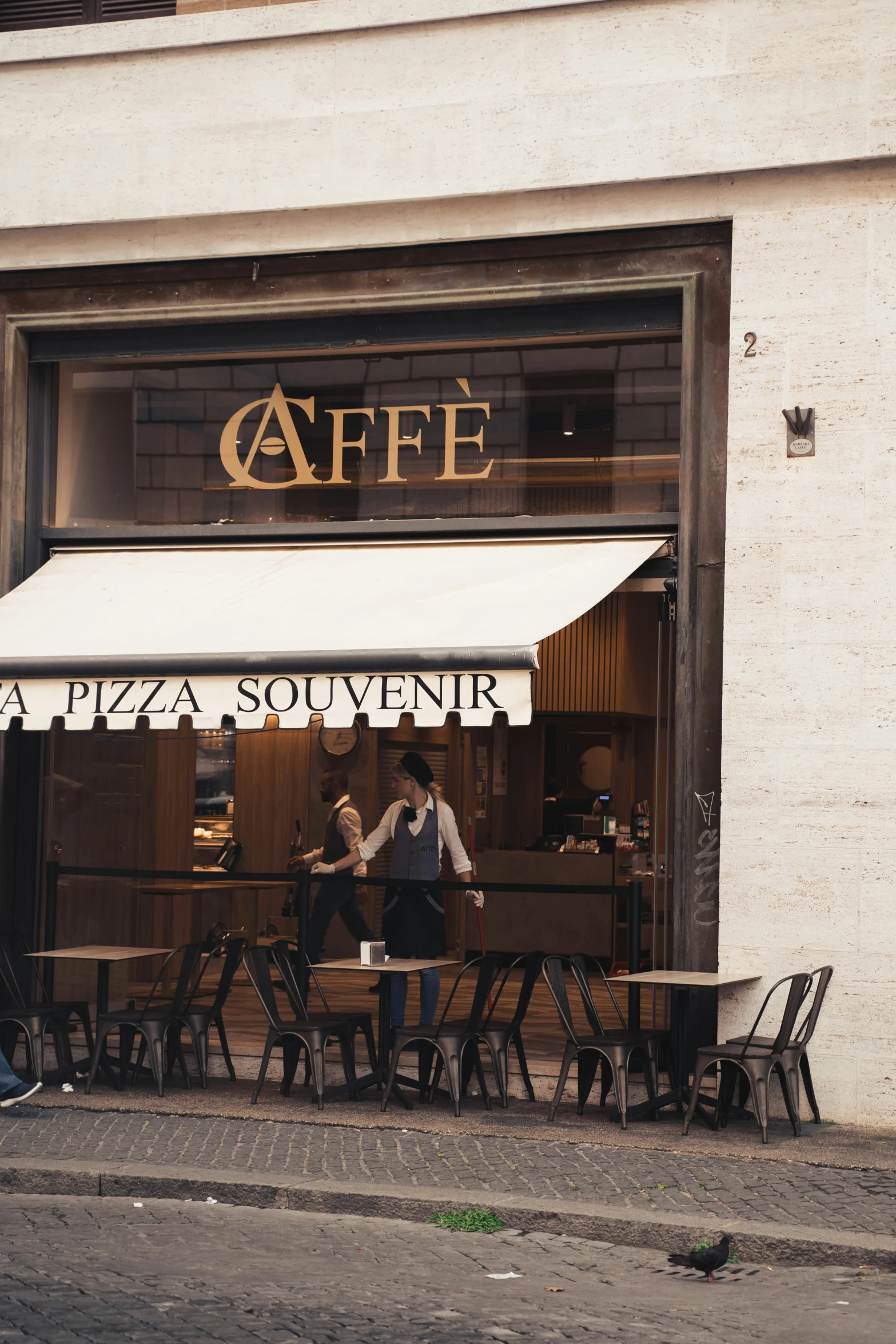 two men standing outside a restaurant, talking