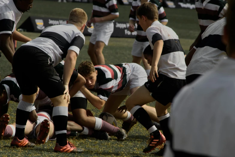 the men are playing rugby on the field