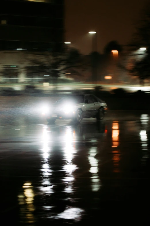 a blurry image of an suv at night with headlights on