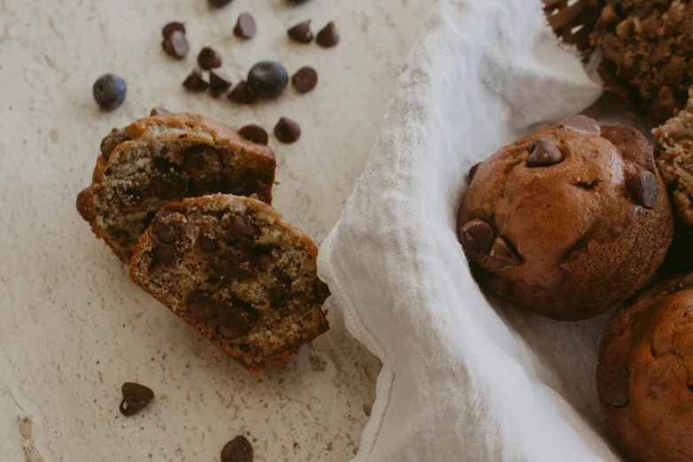 a muffin is on a towel with chocolate chips