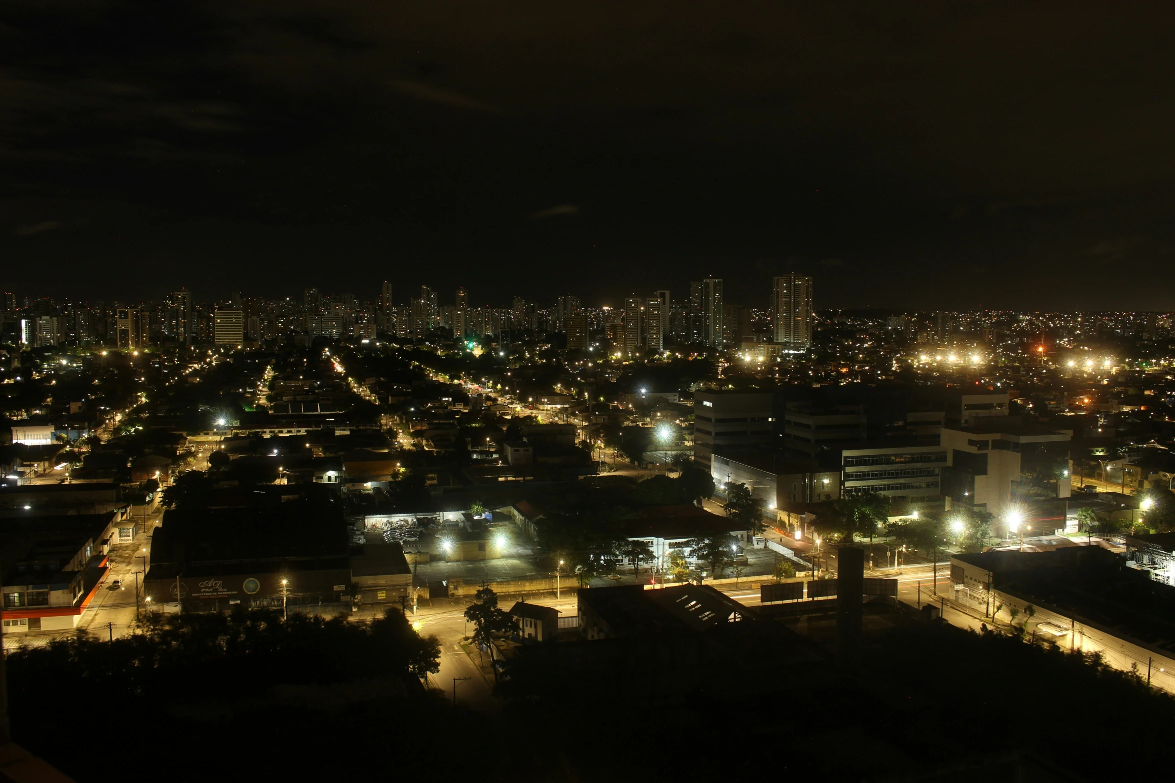 a nighttime city with large buildings and lots of lights