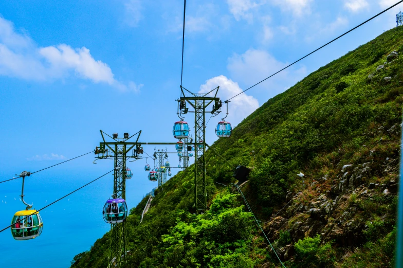 a scenic view of a green mountain side area with hills