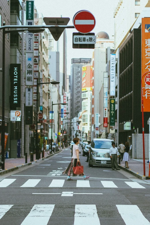 a person with a bag is crossing the street