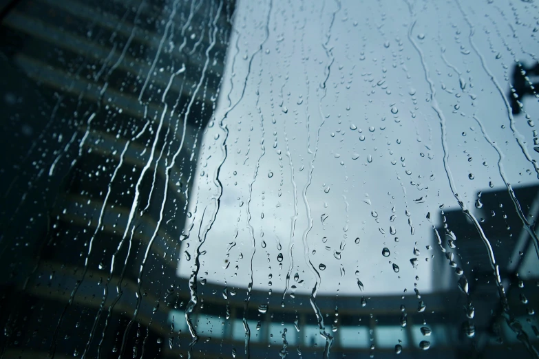 rain droplets on the window pane and a city view