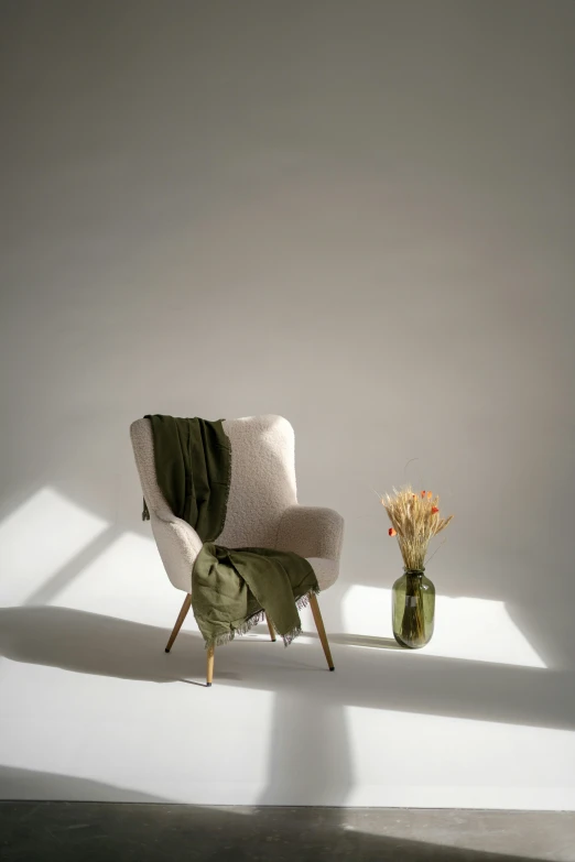 a chair with a vase sitting next to it