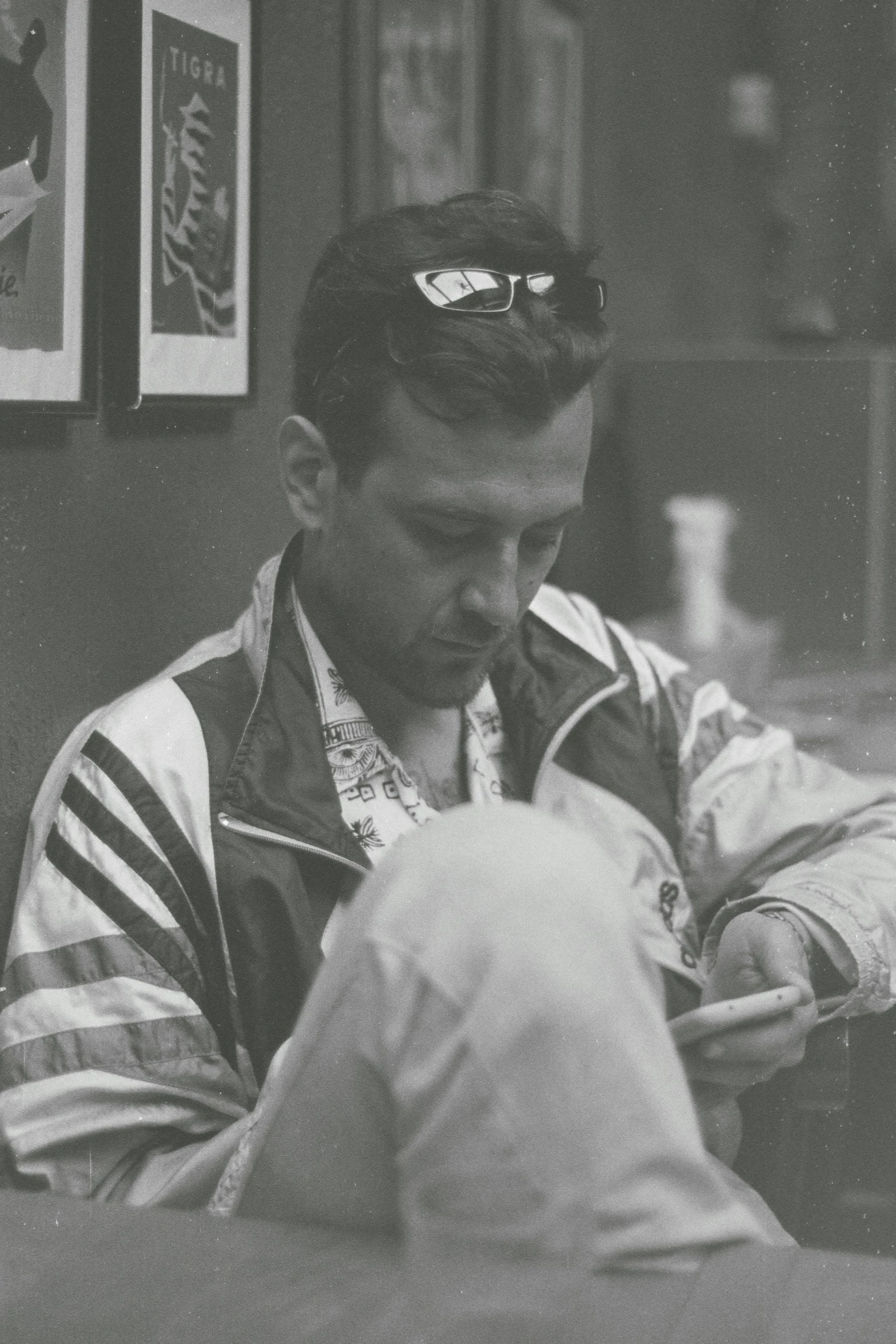 a man with goggles looking down as he is holding a bag