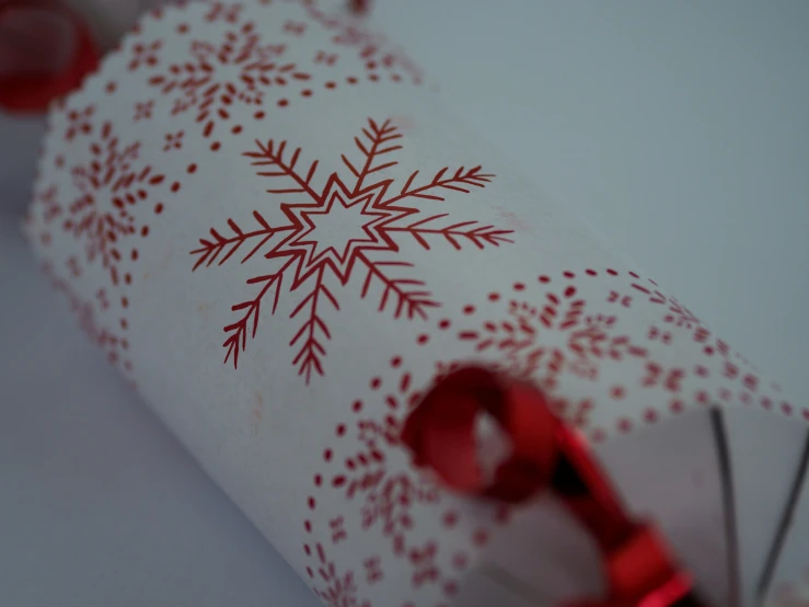 the tube is decorated with red and white patterns