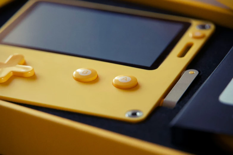 a yellow and black electronic device with ons