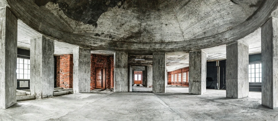 the room is filled with concrete and brick pillars