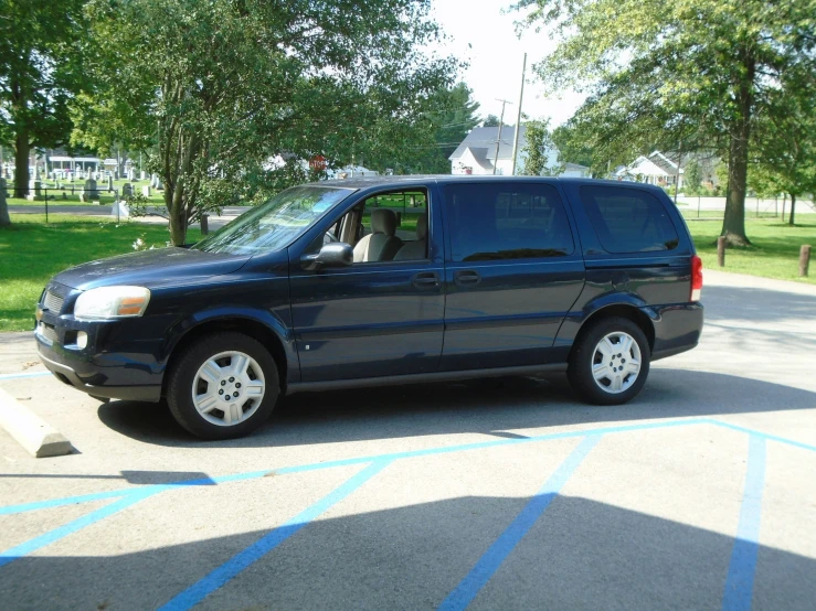 a blue van parked in a parking lot