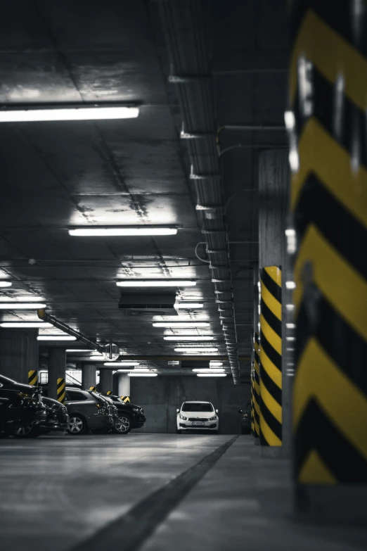 a parking garage with several cars parked next to one another