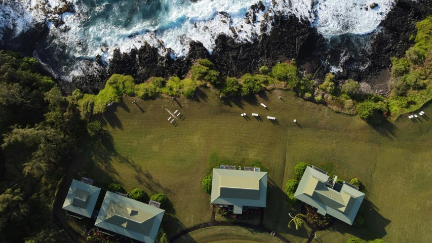 aerial view of several homes sitting by the ocean