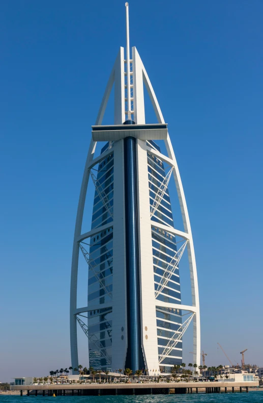 a tall building in the ocean that looks like it has a boat on its side