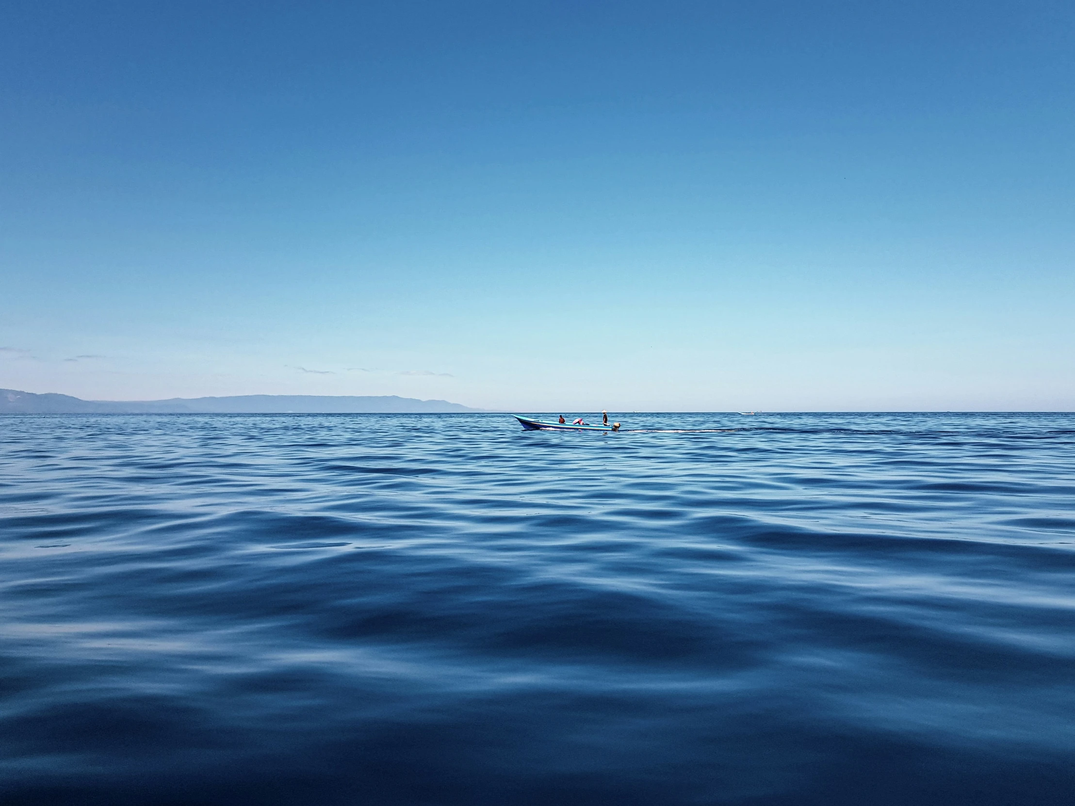 a person rowing a boat across the ocean