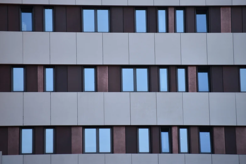 large multicolored building with lots of windows next to it