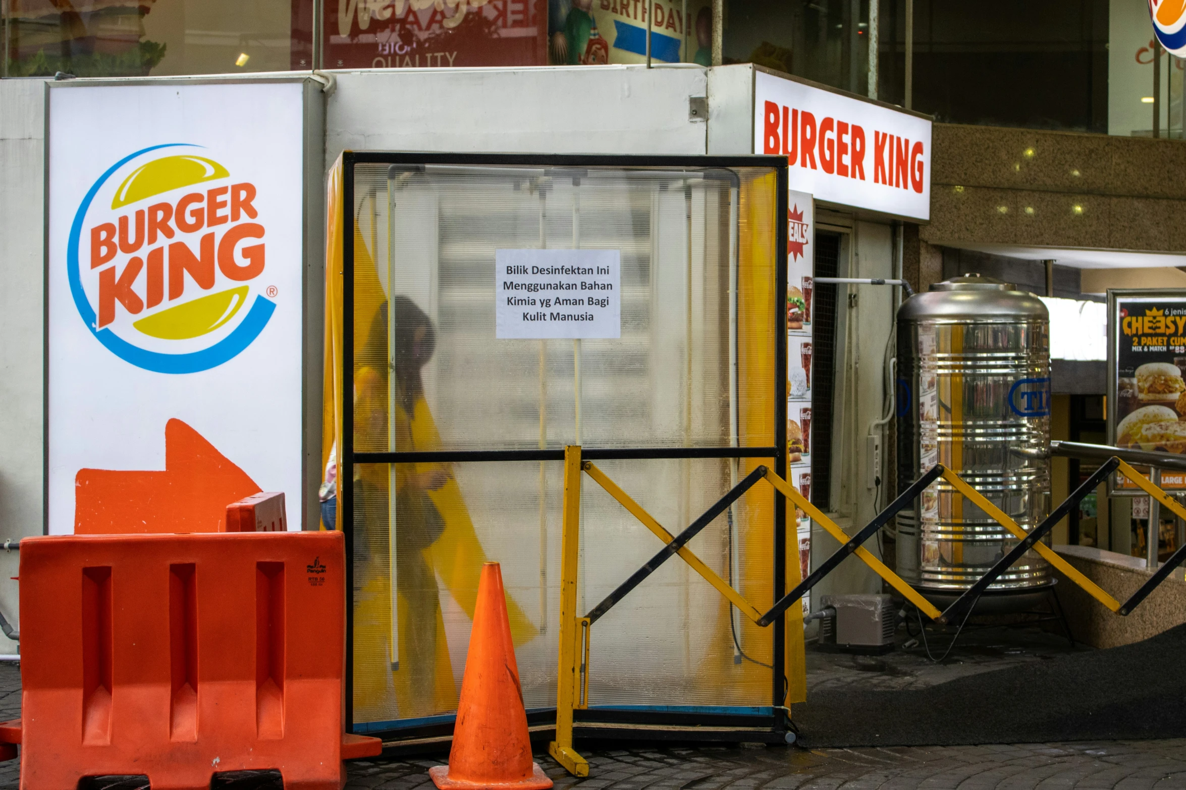 a storefront with a closed and broken window and signs