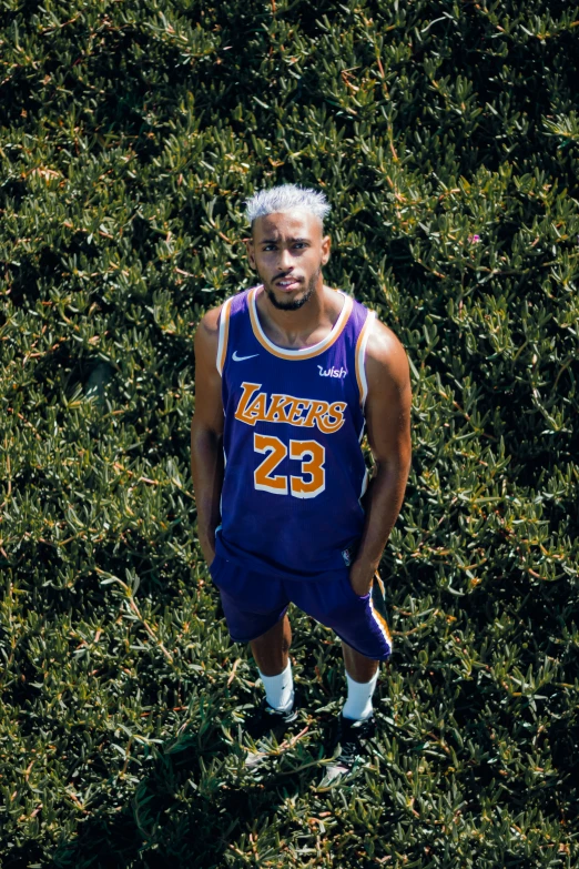 the young man is posing on his basketball uniform