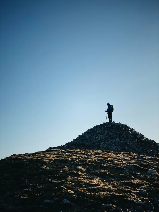 a person is standing on top of the mountain