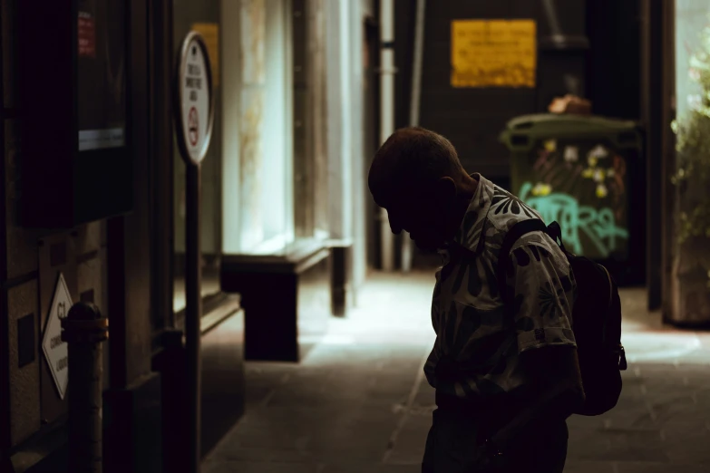 a man in an alley walking through an indoor area