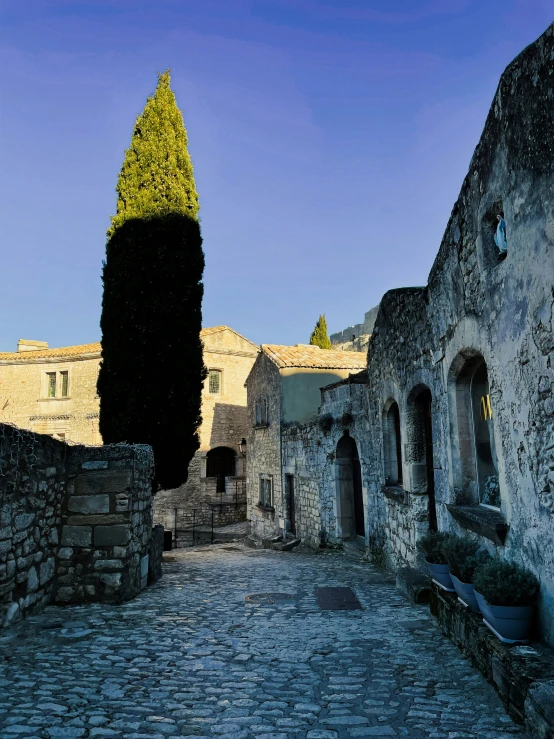 a stone path next to an old brick building