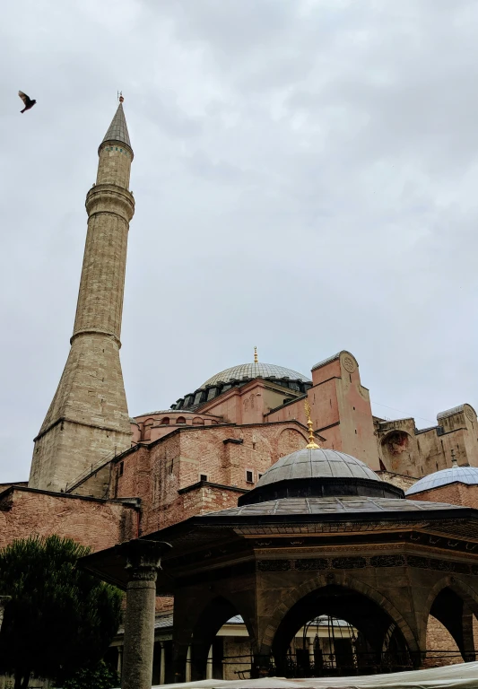 a tall building next to a tower with a clock on it