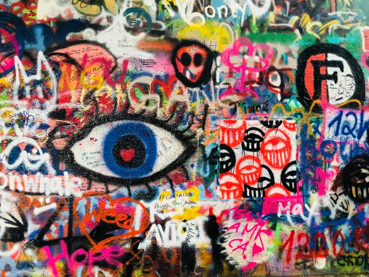 an artistic wall covered in colorful graffiti