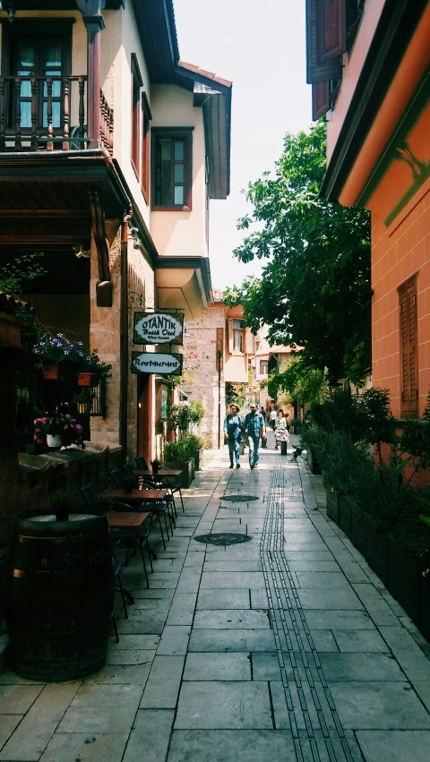 several people walking down a city street while others walk by