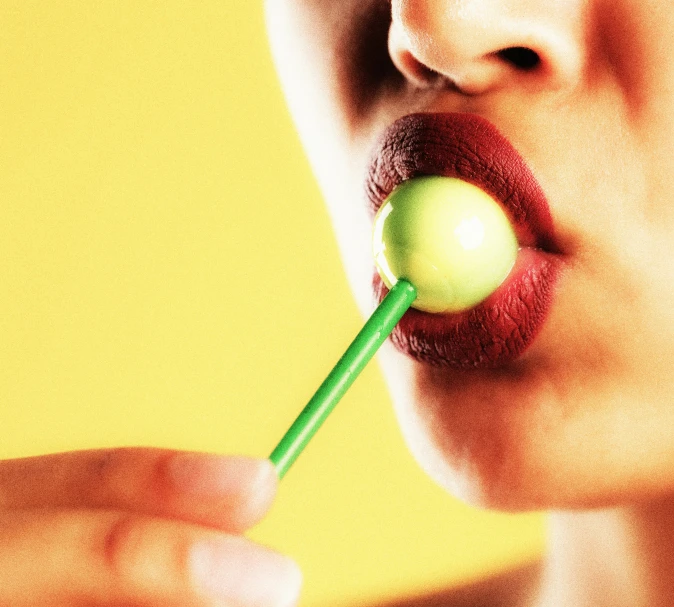 woman with a green stick in her mouth