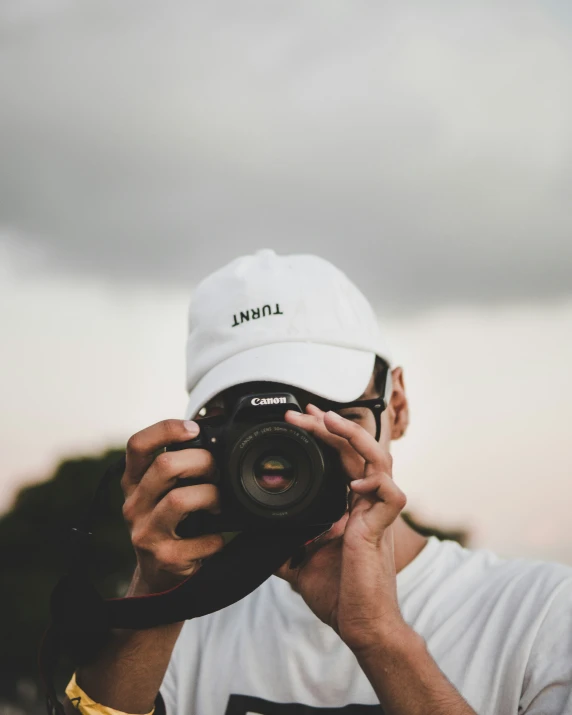 a person holding a camera in the air